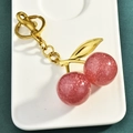 Sparkly dark pink cherry keychain with gold metal leaves and glitter resin charms - Pink