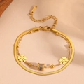 Detailed macro of gold double-layer bracelet with clover charms and S925 silver tag - T408 Gold Bracelet