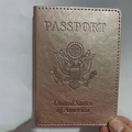 Rose gold US passport holder in pebble grain faux leather featuring a debossed eagle seal - Rose Gold