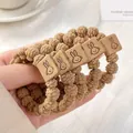 Four pack of khaki bubble texture hair scrunchies with square rabbit leather patch - Plush With Rabbit Tag / Khaki Rabbit