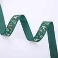 Close-up of dark green Christmas ribbon with gold bronzing deer and snowflake patterns - Gold Stamping Green Deer (2.5cm Width 5m Length)