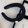 Detail of black faux lamb wool headband with pearl accent and handmade woven label - Headband / Black