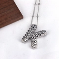 Detailed macro shot of a silver letter K pendant necklace with unique bumpy texture finish - Letter K