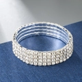 Detailed macro view of four-row elastic silver bracelet with sparkling clear rhinestones - 4 Rows / Silver