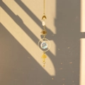 Brass butterfly suncatcher detail with crystal ball casting colorful rainbow light - Mushroom
