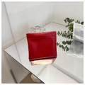 Minimalist red leather mini pouch with squeeze closure shown on a clean mirror surface - Small / Red
