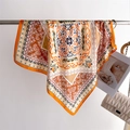 Elegant orange paisley silk square scarf gracefully draped over a metal hanging bar - Orange (FJ995-4)