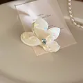 Iridescent white flower hair claw with rhinestone center and 5.5cm resin body - Yellow Small Flower