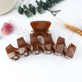 Brown wave-shaped matte hair claw clip for women on a decorative floral background - Brown (UV)