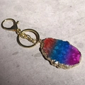 Macro detail of natural agate stone keychain with golden trim and gradient crystal texture - Irregular Size / Rainbow