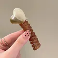 Cute heart-shaped hair claw with brown spiral telephone wire band for kids - Beige Heart/Amber Spiral