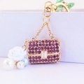 Gold keychain with purple rhinestone handbag pendant, white flower and pearl accents - Individual Packaging / Purple