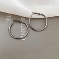 Detailed view of metallic gunmetal hoop earrings displayed on stylish beige fabric - 3cm / Gunmetal