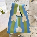 Close-up of blue and green striped knit handbag featuring white floral jacquard patterns - Blue Sky White Clouds