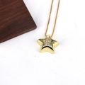 Close-up of a gold star-shaped pendant with a sparkling diamond letter P on a snake chain - Letter P