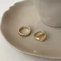 Detail of matte 18K gold plated rings with twisted texture and irregular wave design - Adjustable Open / Two-Piece Set