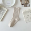 Minimalist beige mid-calf cotton socks with seamless cuff shown on cozy tabletop - Khaki