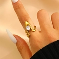 Gold plated wrap ring with pear cut zircon stone shown on a model's hand - Waterdrop Zircon Irregular Wrap Style (DZ-061)