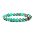 Detailed view of round natural turquoise beads with unique brown marble texture - Green Shoushan Stone