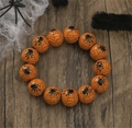 Detail of Halloween wooden beaded bracelet featuring black spider and web prints on orange beads - Orange Black Spider Web