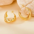 Detailed macro view of 316L gold earrings with spiral texture on a natural stone base - 25mm (PJER289) / Gold