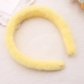 Close-up of soft yellow plush headband on a white fuzzy blanket with floral accents - Yellow (Faux Rabbit Fur)