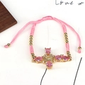 Bracciale in corda rosa intrecciata con pendente a croce dorata e pietre di zircone rosa - Rosa