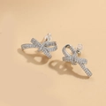 Silver bow earrings with micro-inlaid rhinestones on a minimalist beige background - ES2560 Long Bow