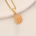 Macro shot of light orange natural stone pendant with gold cross and stainless box chain - Pink Aventurine