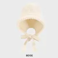 Winter knitted earflap beanie for women in beige featuring a cozy tie-up bow closure - M (54-58cm) / Off White