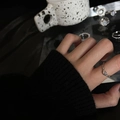 Silver adjustable ring with twisted knot design and black zircon in a lifestyle setting - No. 43 Open Ring
