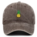 Detailed view of yellow pineapple embroidery on vintage washed cotton baseball cap - Coffee