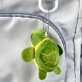 Close-up of a green plush turtle keychain with bead chain attached to a grey backpack - 9cm / Green Yellow