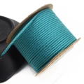 Macro detail of 1.5mm lake blue braided cotton cord neatly wound on a paper spool - Approx. 1.5MM / Cyan