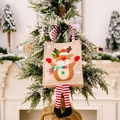 Christmas reindeer gift bag with striped legs hanging on a snow decorated tree - Elk Style