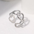 Silver adjustable heart ring featuring hollow-out patterns on a white textured surface - Steel - Hollow Heart