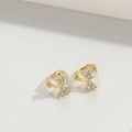 Exquisite gold butterfly earrings with sparkling white zircons on a white textured background - Bowknot (Hourglass) / Gold
