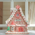 Casa de caramelos de jengibre iluminada con detalles de glaseado y figura de hombre - Lazo Gigante 19*16*24cm