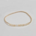Close-up of handmade elastic bracelet featuring gold beads and faceted amethyst crystals - Citrine