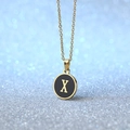 Minimalist gold necklace with a black round enamel pendant featuring a gold letter X - Letter X