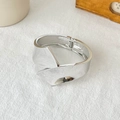 Detailed macro view of the internal hinge mechanism on a wide irregular silver cuff bracelet - Streamlined Cross Pleated Hinged Bangle (SL275) / Silver