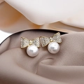 Elegant gold bow earrings with white pearl and rhinestone accents on silk backdrop - Bowknot Rhinestone Pearl Style (E4430)