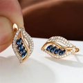 Leaf-shaped champagne gold earrings featuring micro-pave zircons and four blue crystals - Champagne Gold Royal Blue