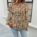 Bloemenblouse met lange mouwen, ruffelmanchetten en peplumzoom in zwart-geel dessin - S / Geel