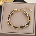 Detail of woven gold stainless steel and black leather chain bracelet with lobster clasp - Gold Black Leather Braided Style (5104)