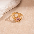 Detailed macro view of a gold-finish hollow ring featuring a sparkling oval pink gemstone - Gold Oval Irregular