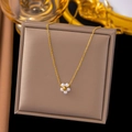 Detail of a gold flower pendant with six white pearls displayed on a brown jewelry box - [H6168] Pearl Flower Gold