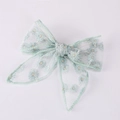 Close-up of light green mesh bow hair clip with detailed daisy flower embroidery - Light Green