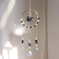 Detailed suncatcher with gold ring, raw black stone, blue star, and crystal drop - Obsidian