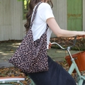 Large leopard print canvas tote bag carried by a cyclist for a stylish outdoor look - Brown Leopard